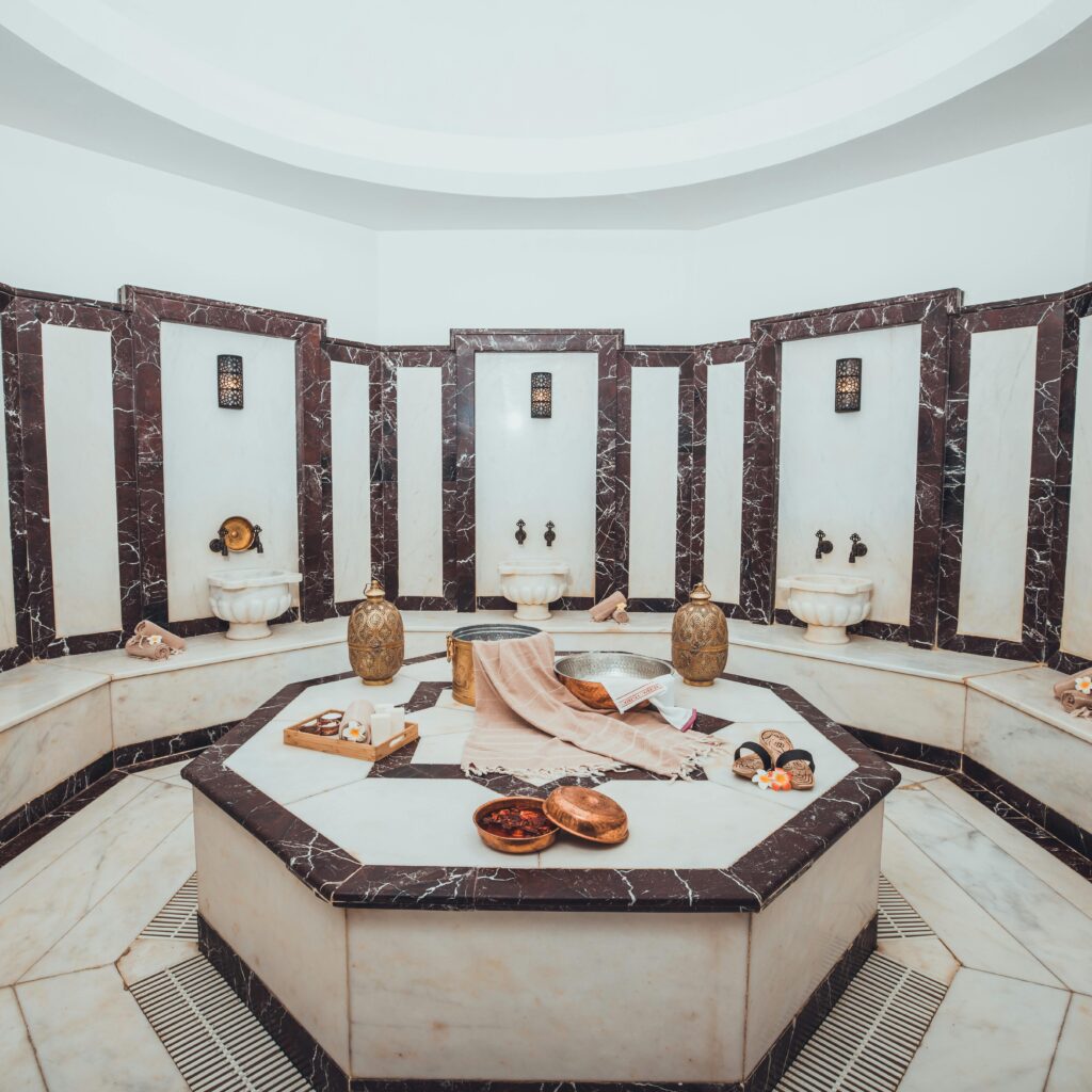 Experience relaxation in an opulent Turkish hammam spa, featuring marble decor and traditional spa elements.