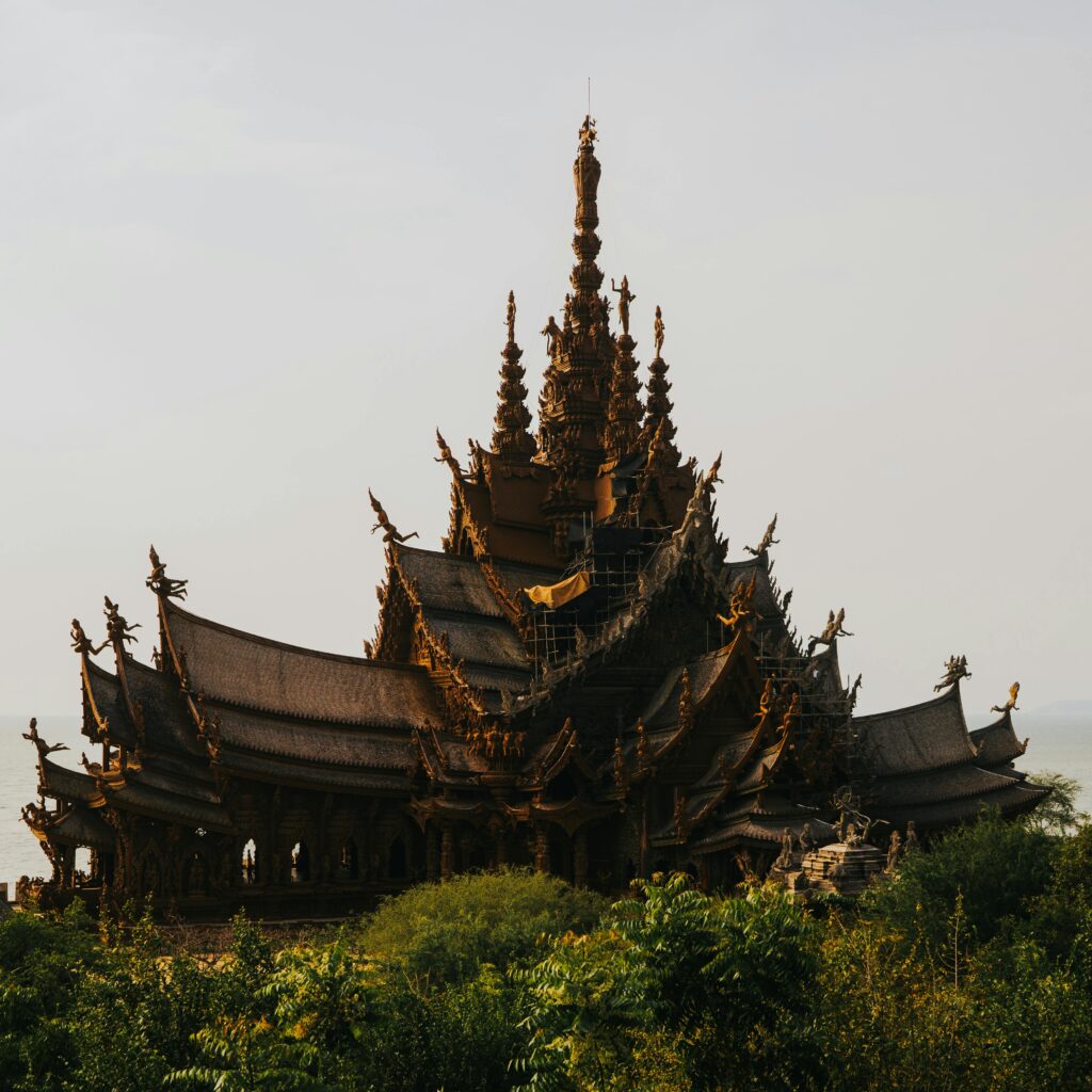 Magnificent wooden temple with intricate carvings in Bangkok, Thailand, captured at sunset.
