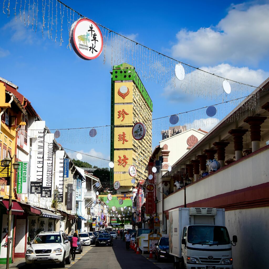 Vibrant view of Chinatown in Singapore featuring People's Park Complex under blue skies.